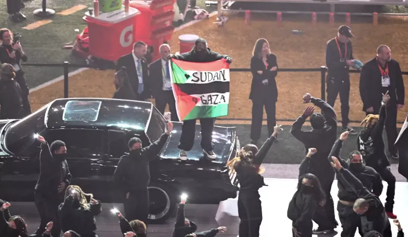 He displayed both Palestine and Sudanese flags together